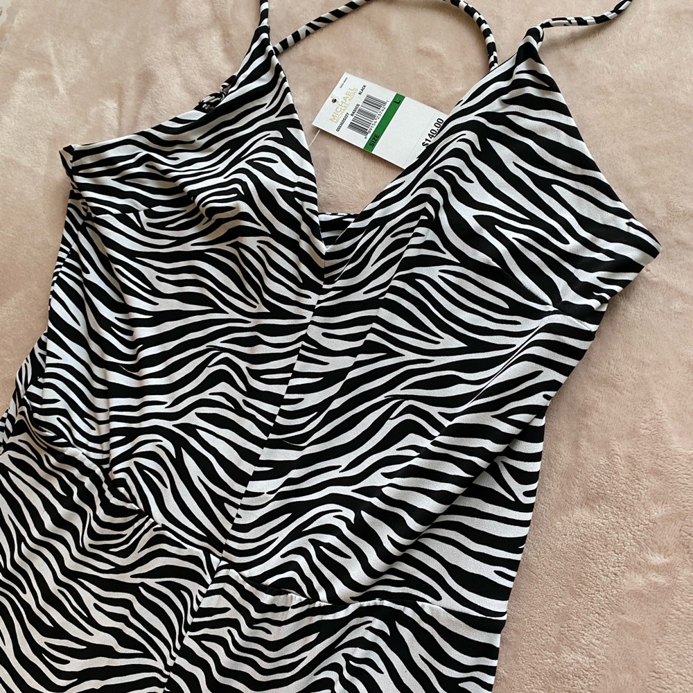 Zebra stripped jumpsuit. Cross cross back, side zipper. Never worn - tags on